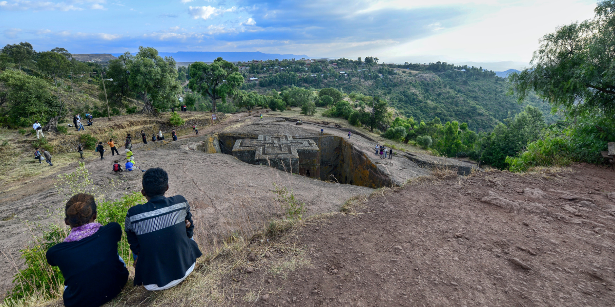 A man and woman overlooking one of the Churches of Lalibela