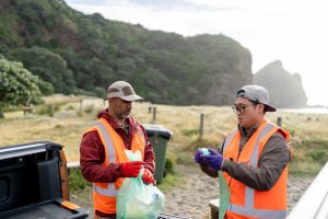 volunteers working on the beach to get rid of plastic waste