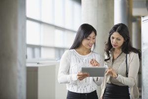 Businesswomen looking at digital tablet